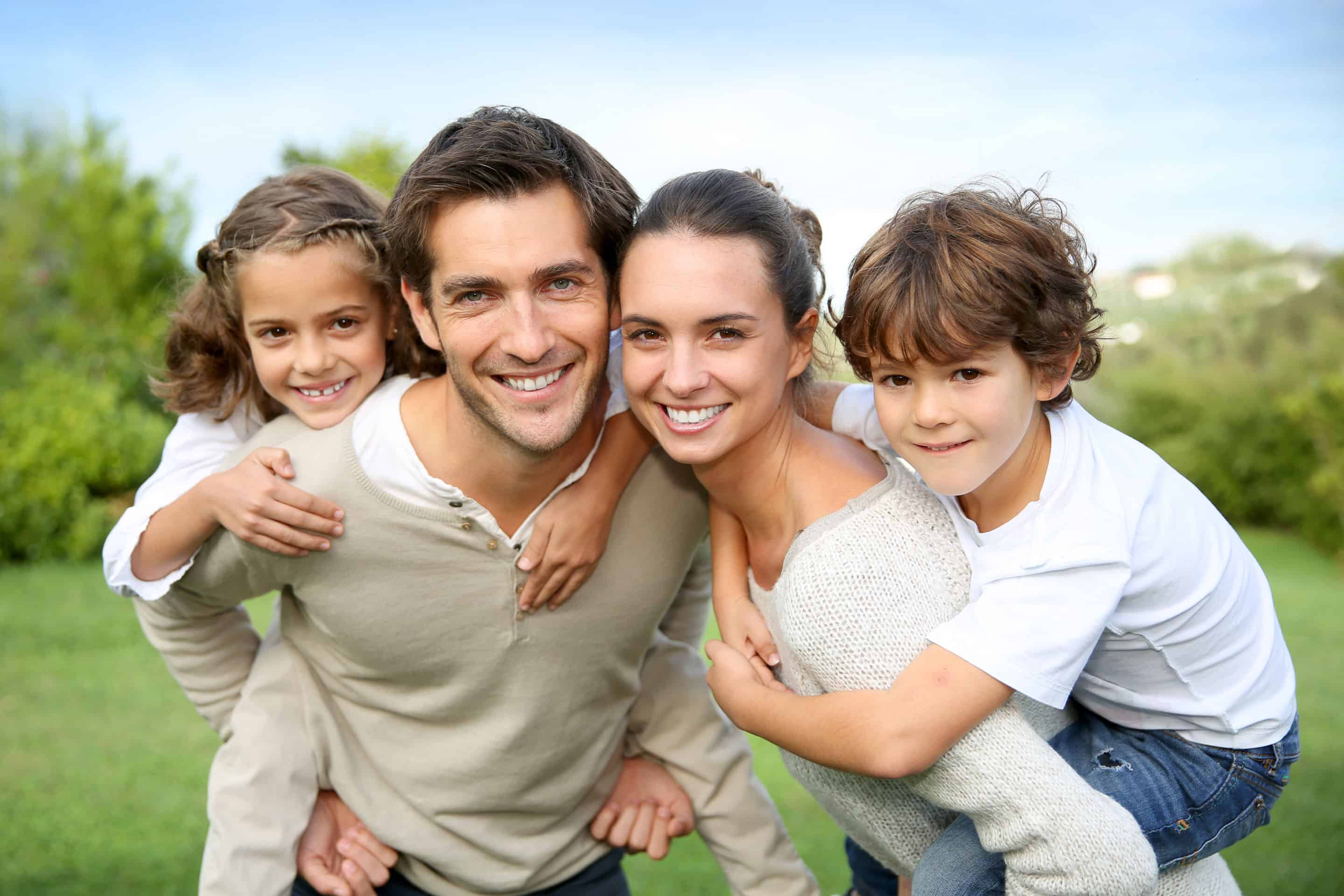 A smiling family outdoors