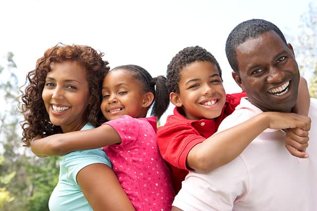A smiling family, from the Sherwood Dental site